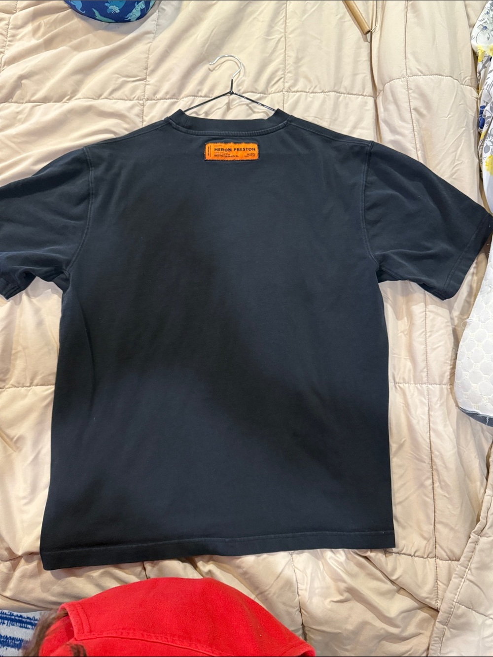 Heron Preston Black Short-Sleeve Tee with Orange Logo Patch does have spots.